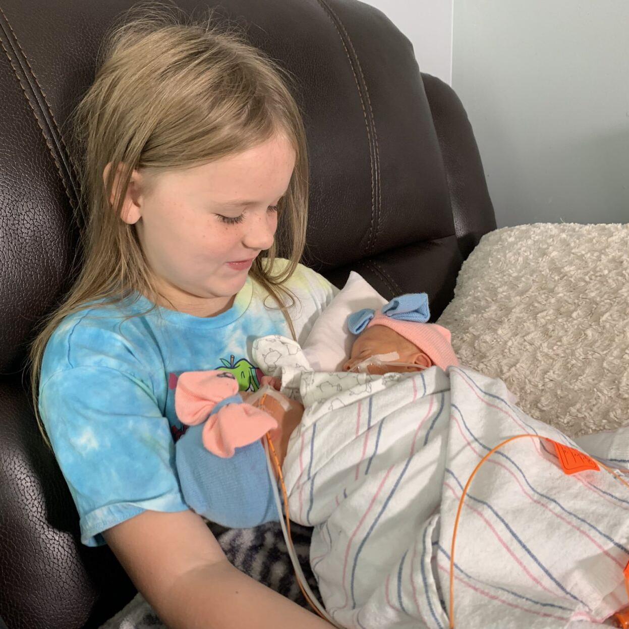 Sister Layla holds twins